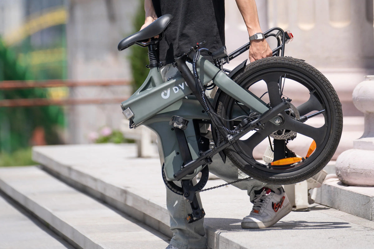 Personne portant le vélo électrique pliant DYU T1 plié