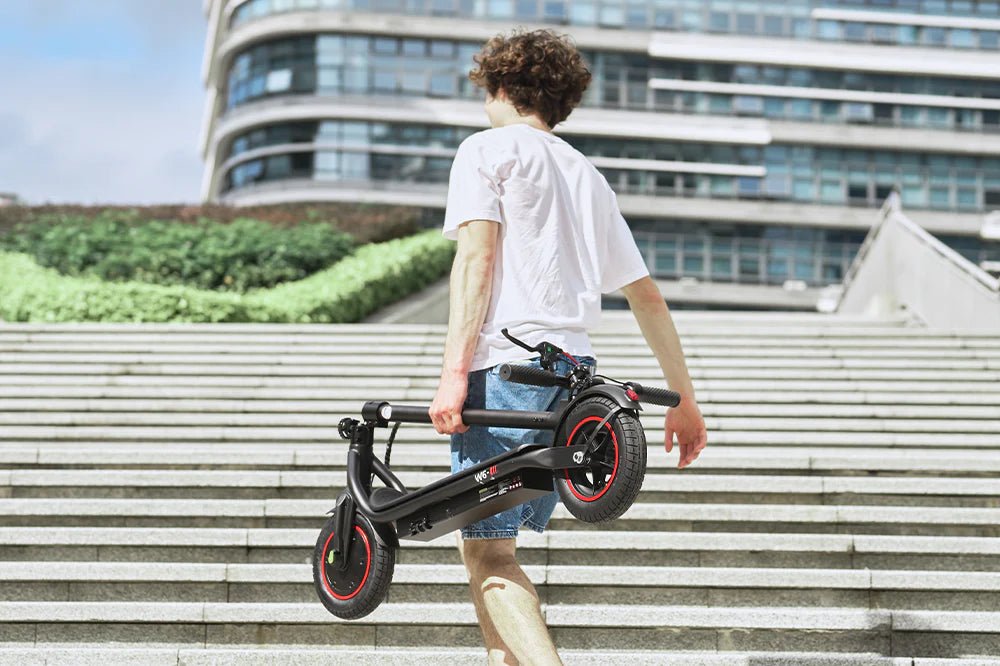 Personne portant la trottinette électrique iScooter W6 pliée